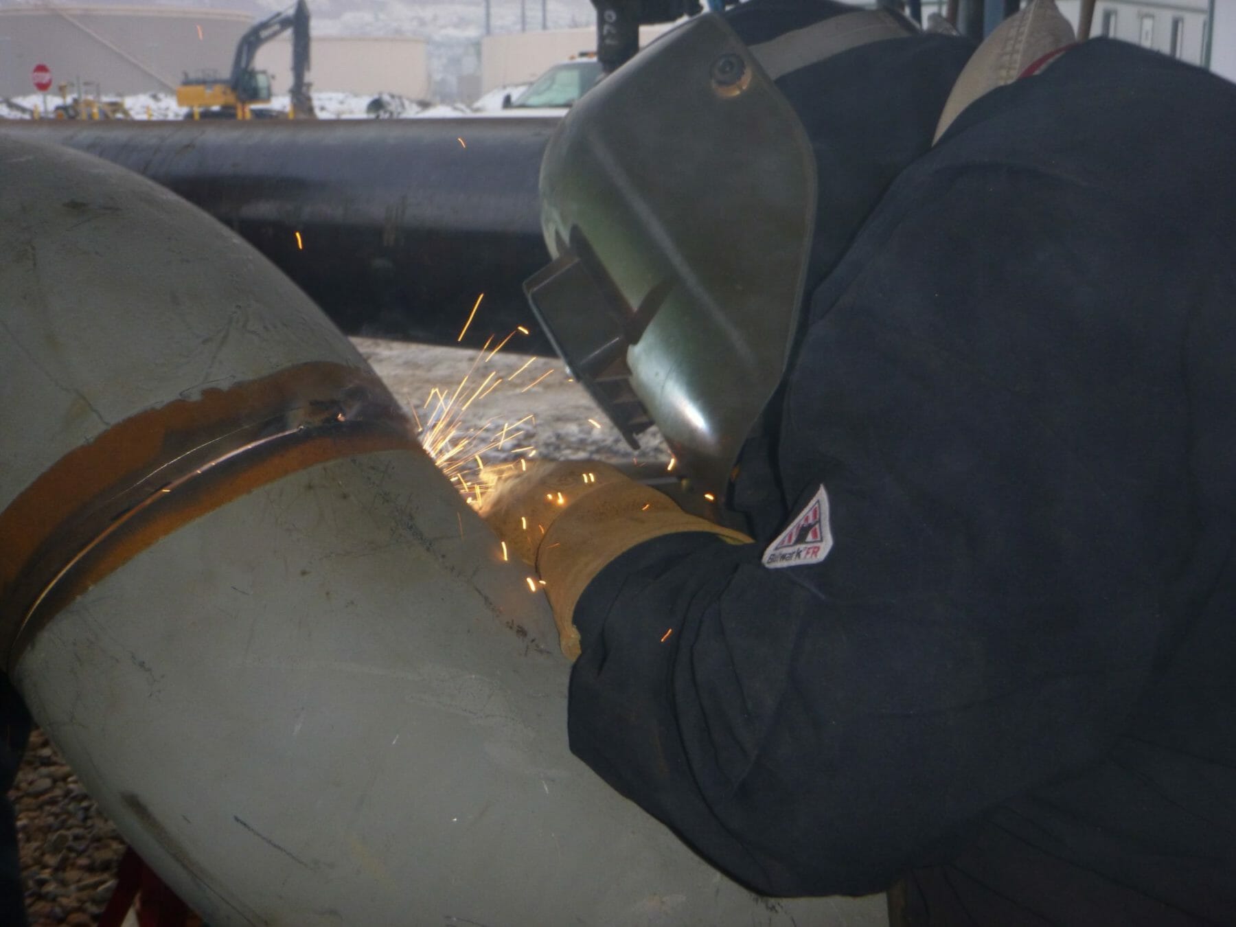 Welder Connecting Metal Pipes | Oil & Gas Refinery Construction Projects | Judson Construction Company