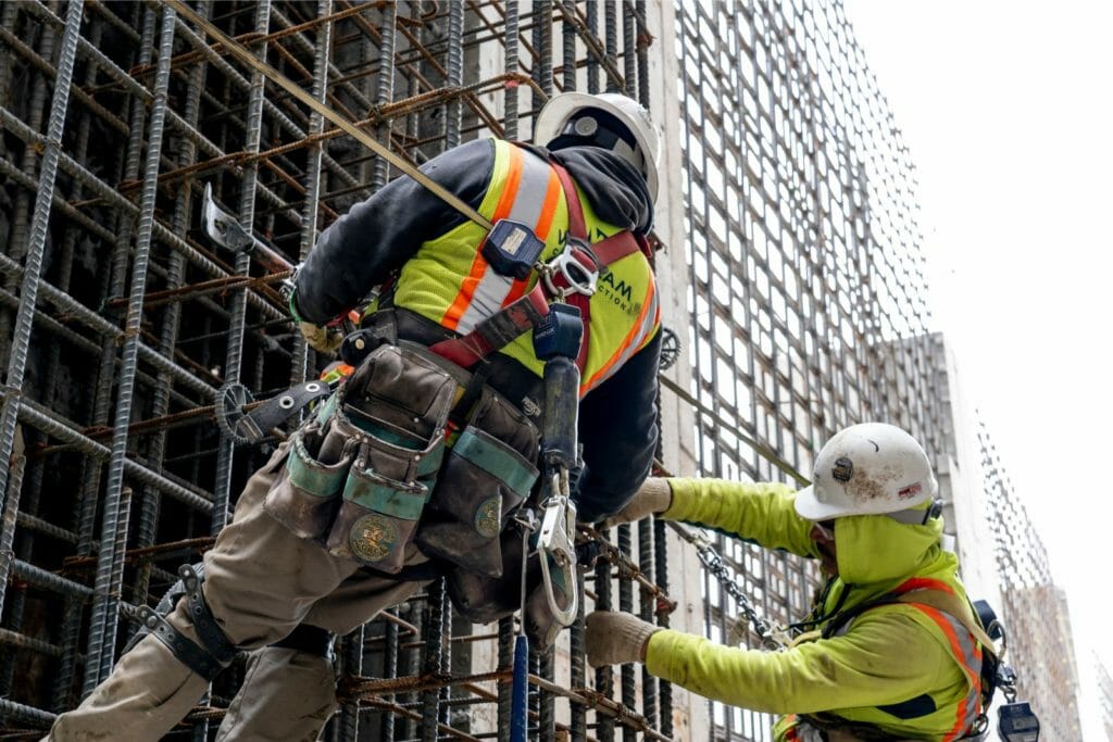 Workers Preparing Rebar For Concrete